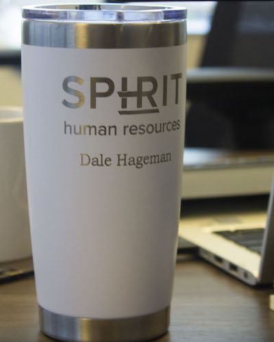 Spirit HR travel coffee mug on desk